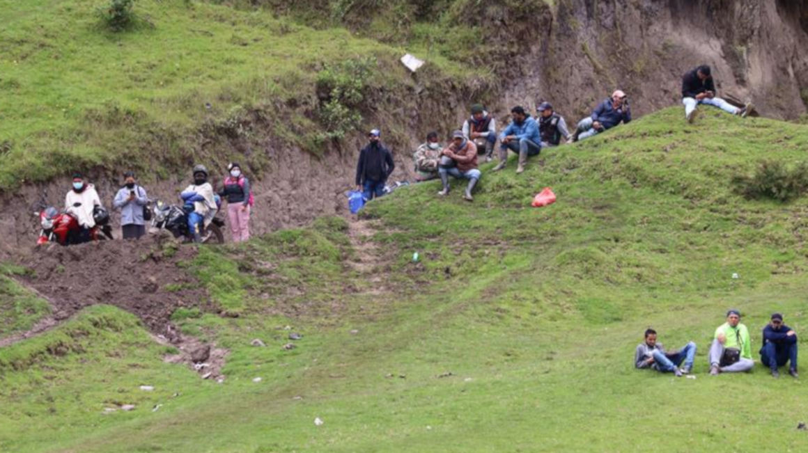 Migrantes venezolanos descansan en una de las colinas junto al cauce del fronterizo río Carchi, mientras esperan que se disperse una operación conjunta militar entre Ecuador y Colombia para evitar al tránsito por pasos ilegales, el 29 de enero de 2021.