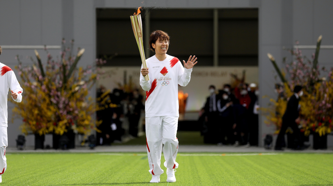 Azusa Iwashimizu, miembro del equipo nacional de fútbol femenino de Japón, corriendo con la antorcha de los Juegos Olímpicos de Tokio en el Centro Nacional de Entrenamiento J-Village en Naraha, prefectura de Fukushima, el 25 de marzo de 2021.