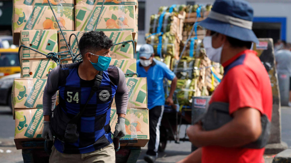 Fotografía de archivo del 9 de junio de 2020 que muestra trabajadores en el Mercado Mayorista de Frutas de Lima (Perú). 