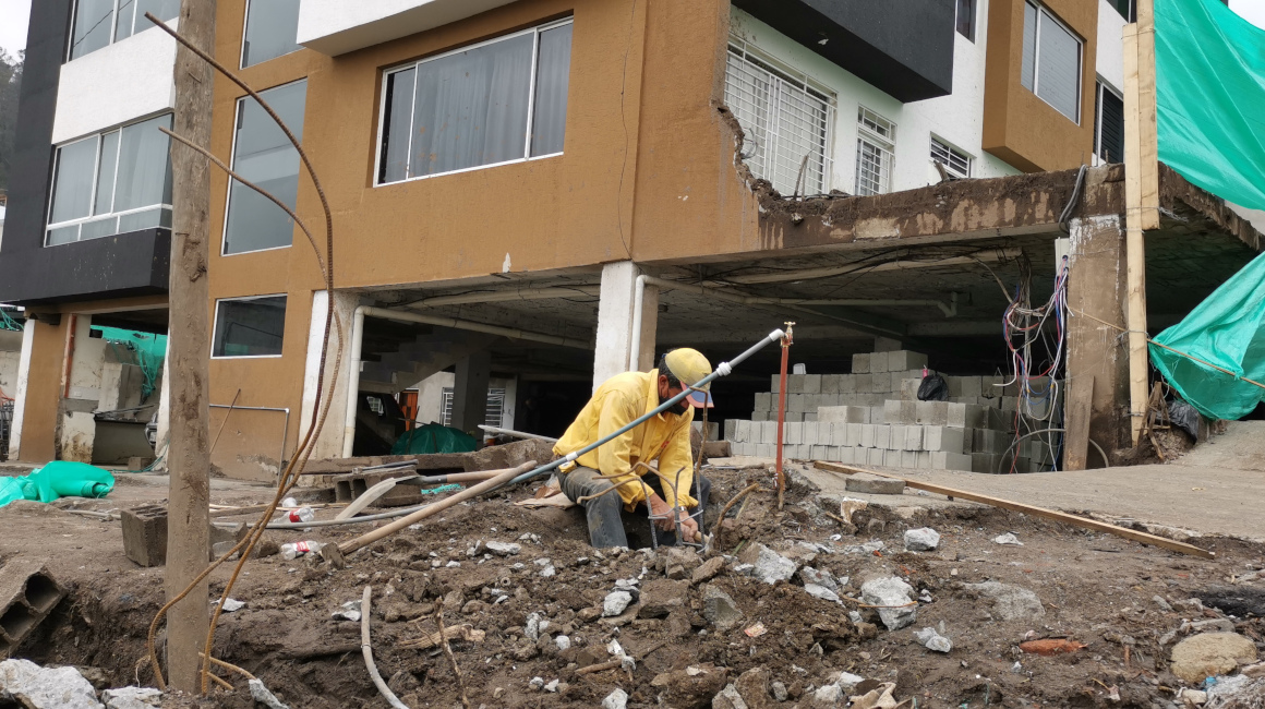 Una persona instala una columna en una de las casas destruidas por el aluvión en el sector de La Comuna, en el norte de Quito, el 7 de febrero de 2022.