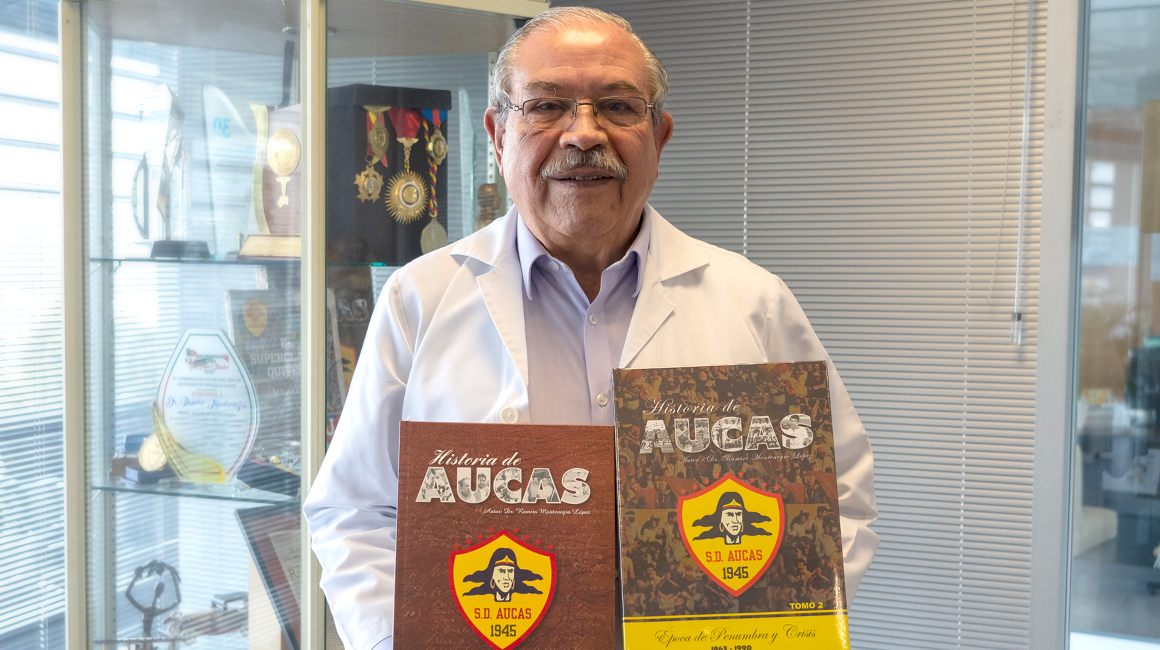 El Dr. Ramiro Montenegro, con las enciclopedias de la historia del Aucas. 