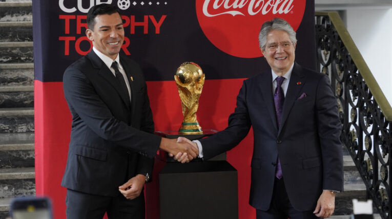 El presidente de la República, Guillermo Lasso, y el exfutbolista brasileño Lúcio, con el trofeo de la Copa del Mundo, en Quito, el 31 de octubre de 2022.
