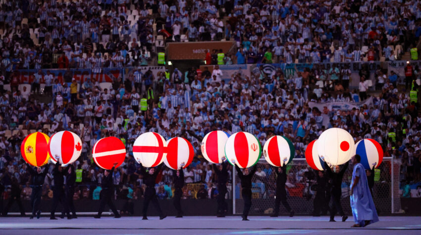Voluntarios con globos con las banderas de los países del Mundial.