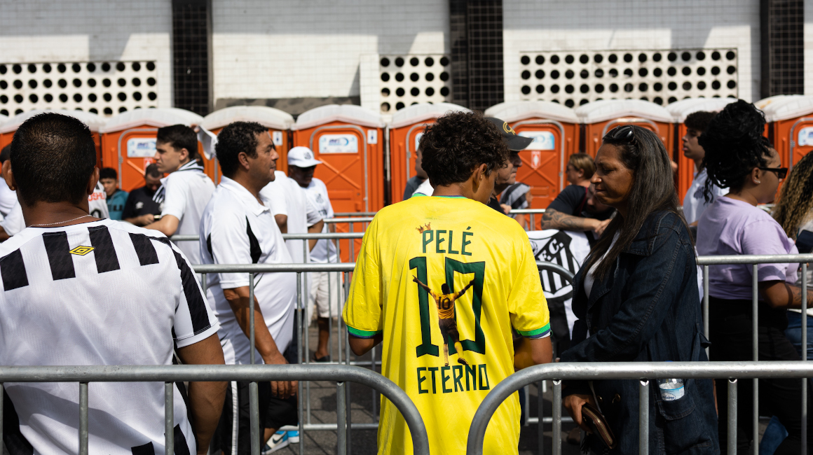 Seguidores del fallecido Pelé llegan al amanecer para asegurar un lugar en la fila frente al estadio Vila Belmiro.