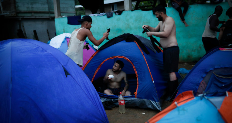 Migrantes levantan una tienda de acampar, en el pueblo de Bajo Chiquito para pasar la noche y descansar antes de continuar con la ruta. Panamá, octubre de 2022.
