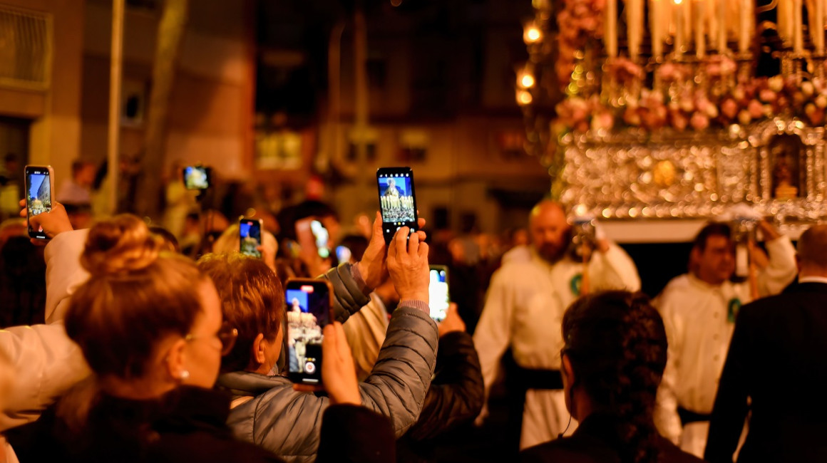Varias personas apuntando las cámaras de sus celulares durante un desfile en Barcelona, España, el 9 de abril de 2023. 