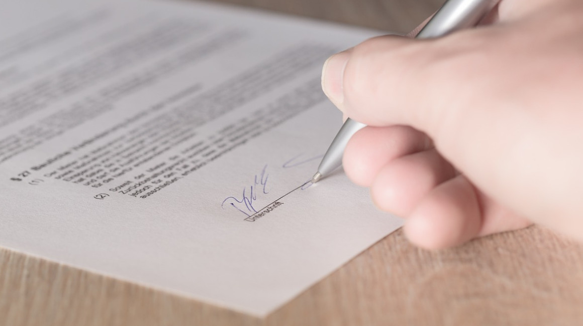 Imagen referencial de la firma de un contrato de consentimiento de uso de datos personales.