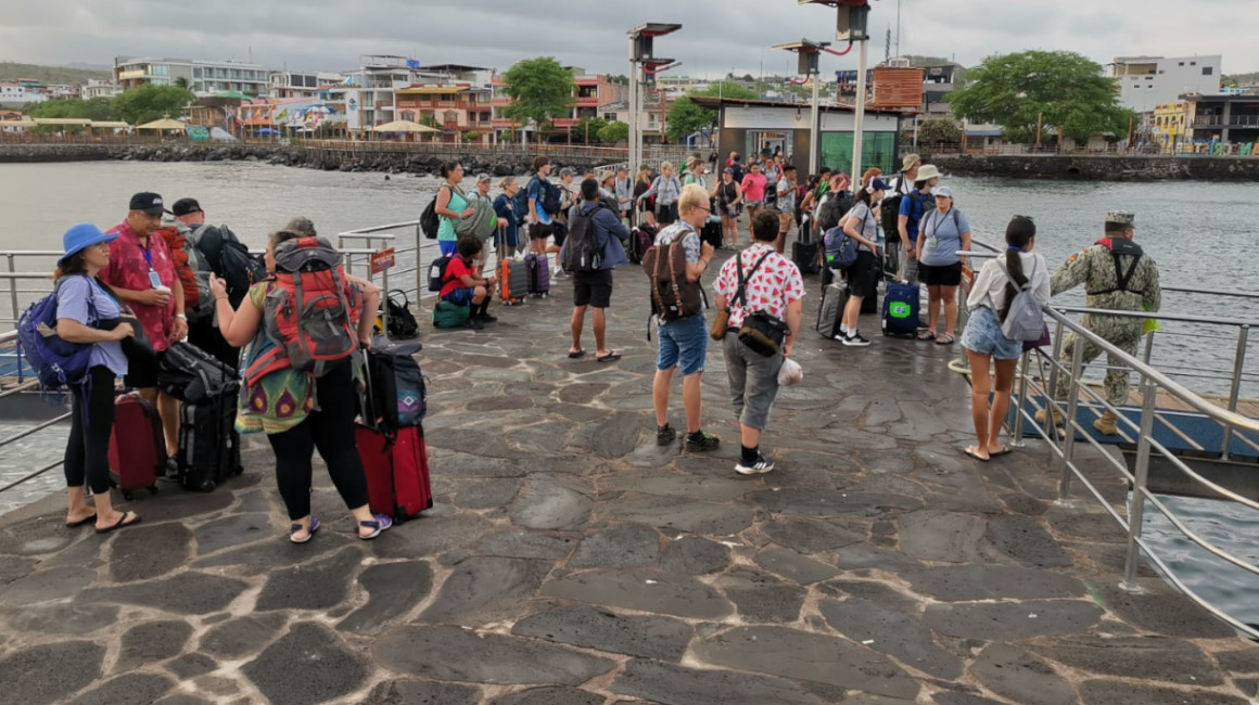 Turistas embarcan para el trayecto entre las islas San Cristóbal y Santa Cruz en el muelle de Puerto Baquerizo Moreno, en Galápagos, el 21 de junio de 2023.