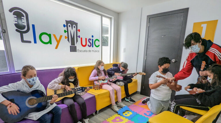 Niños en clases de guitarra en la Escuela Play Music, en 2022.