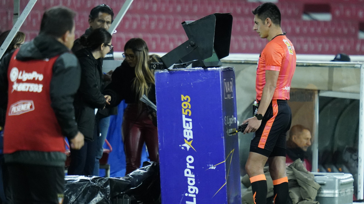 El árbitro Luis Quiroz revisa una acción en el VAR durante el partido entre Liga y Libertad, en el Estadio Rodrigo Paz, el 2 de junio de 2023.
