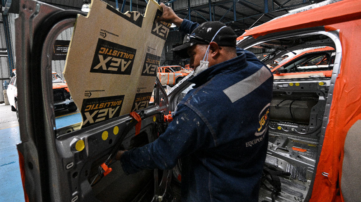 Mecánicos trabajan para blindar un vehículo en el taller de la empresa de seguridad Auto Express en Quito, el 15 de agosto de 2023.