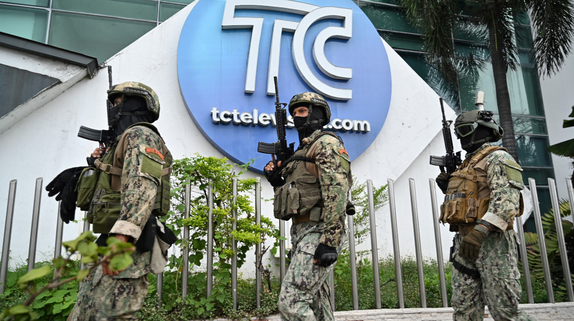 Tres militares caminan en los exteriores del canal TC Televisión en Guayaquil, hasta donde llegaron sujetos armados, el 9 de enero de 2024.