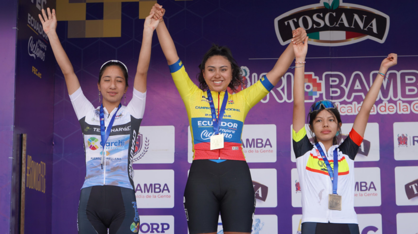 Camila Salgado (medio) levanta sus brazos en el podio del Campeonato Nacional de Ciclismo, en Guano, el 2 de febrero de 2024.