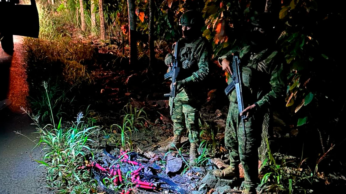 Militares custodian los tacos de dinamita que fueron abandonados en una vía del cantón Camilo Ponce Enríquez, en Azuay.