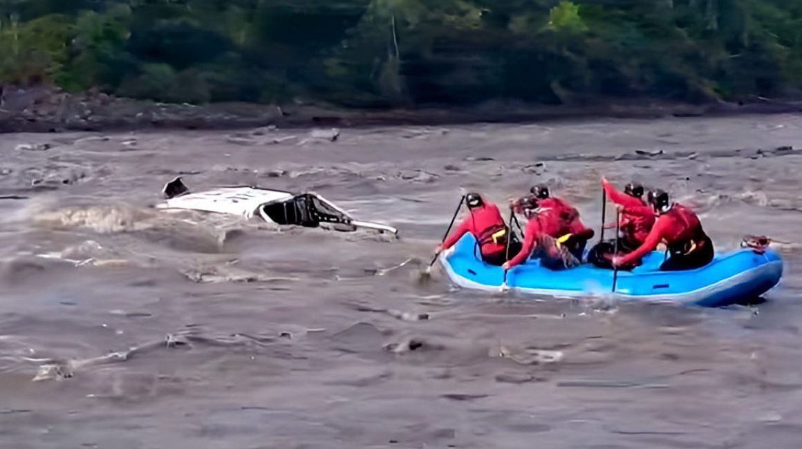 Bomberos buscan a los desaparecidos que cayeron desde un puente en el río Upano.