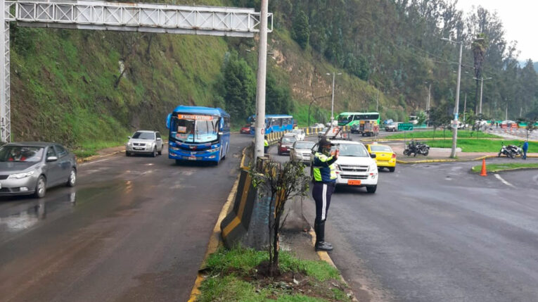 Agente de tránsito controla el tráfico en la Autopista General Rumiñahui.