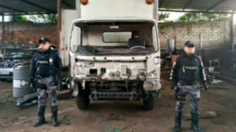 Policías custodian un camión desmantelado en una mecánica de Guamaní, en el sur de Quito.