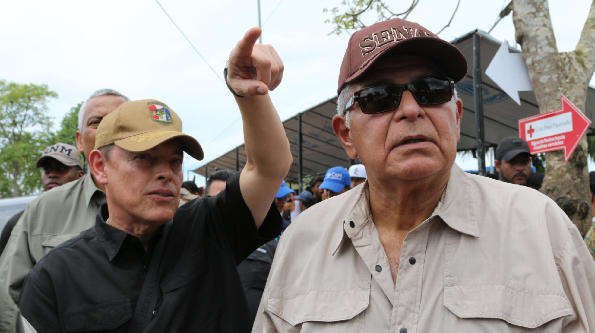 El nuevo presidente de Panamá, José Raúl Mulino (d), camina a su llegada el 28 de junio de 2024, al albergue para migrantes de Lajas Blancas, en Darién (Panamá).